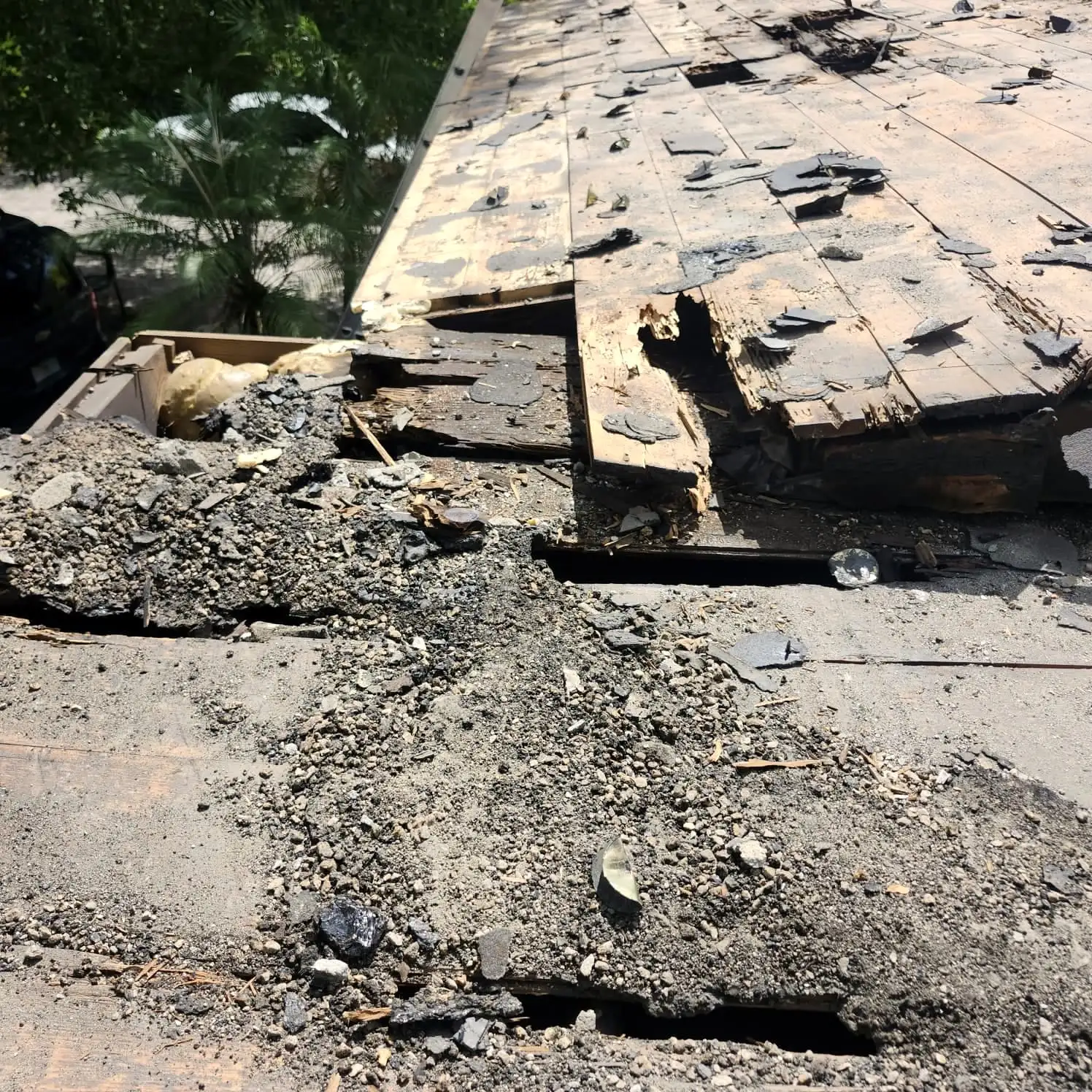 Damaged roofing torn back to the deck, ready for repair