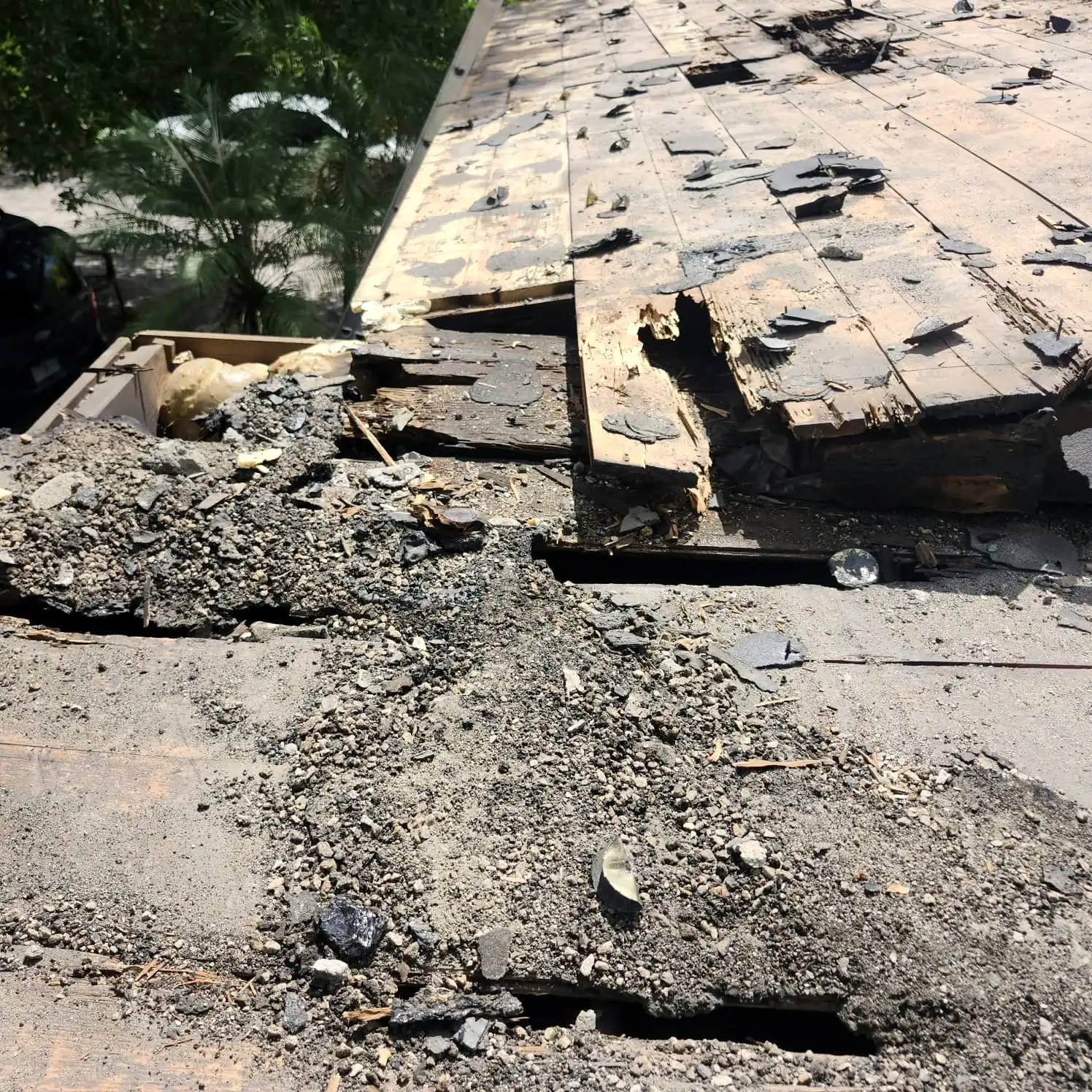 Damaged roofing torn back to the deck, ready for repair